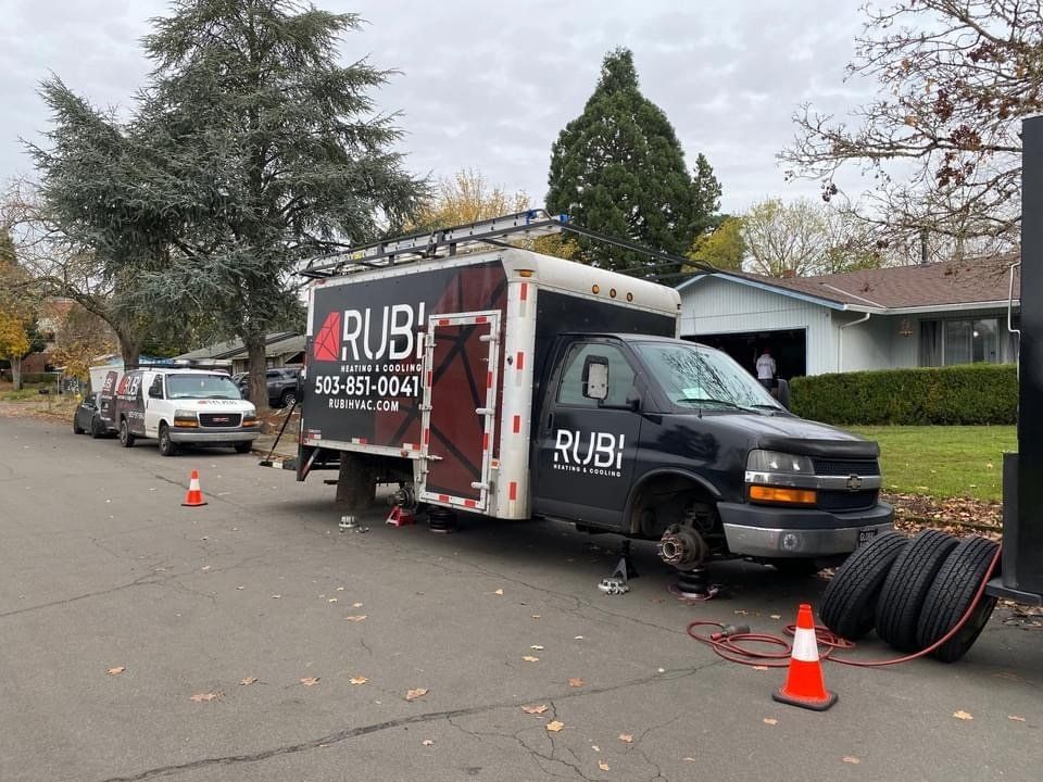 Picture of a HVAC work truck getting new tires.