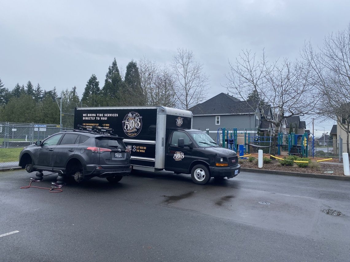 Picture of a small SUV getting new tires.