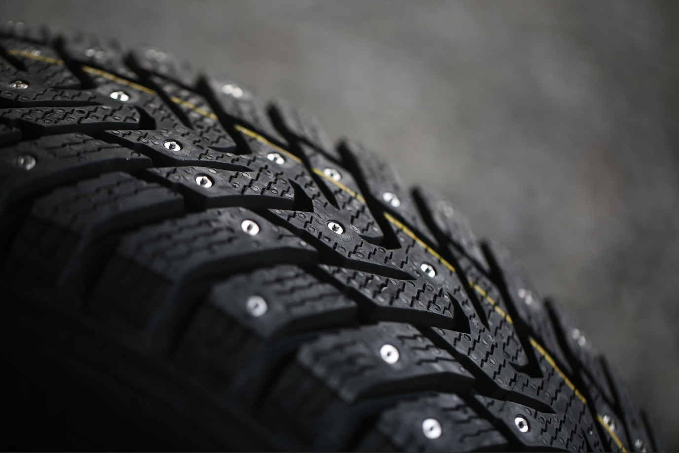 Studded tire on a gray background