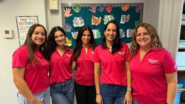 Red sandstone canyon walls, sculpted by water, with a glimpse of sunlight overhead.