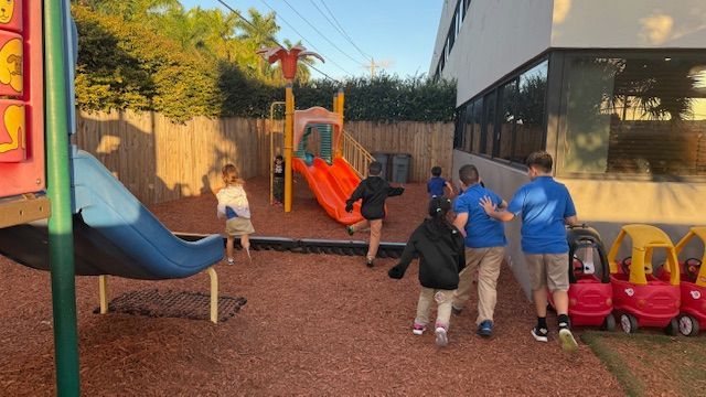 Red sandstone canyon walls, sculpted by water, with a glimpse of sunlight overhead.
