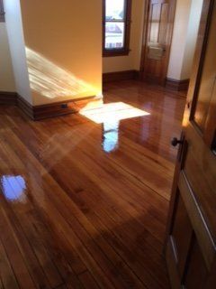 A room with a wooden floor and a door.
