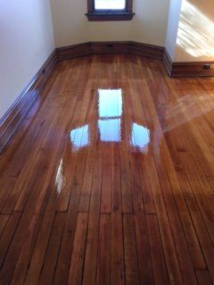 A room with a wooden floor and a window.