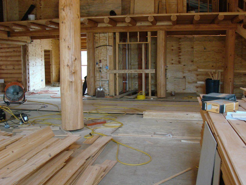 A room with a lot of wood and a fan.