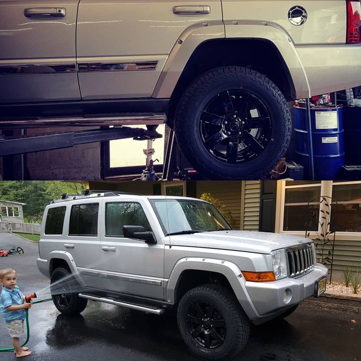 A silver jeep is being sprayed with a hose