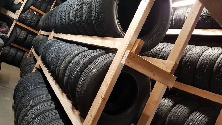 A warehouse filled with lots of tires on shelves