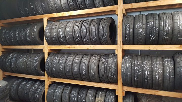 A warehouse filled with lots of tires on wooden shelves