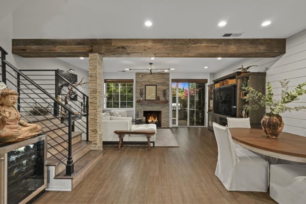 A living room with a table and chairs and a fireplace.