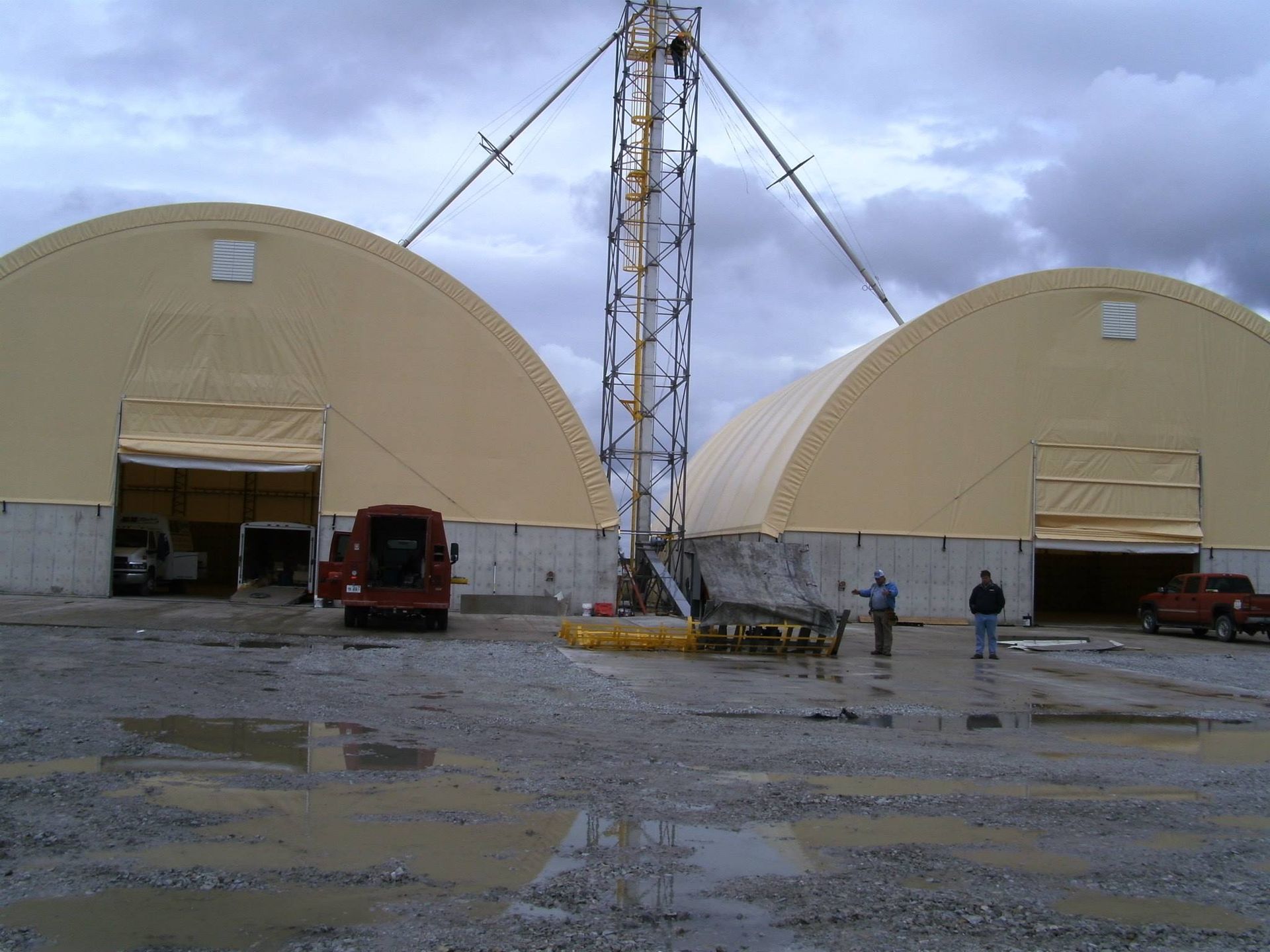 A red truck is parked in front of a crane