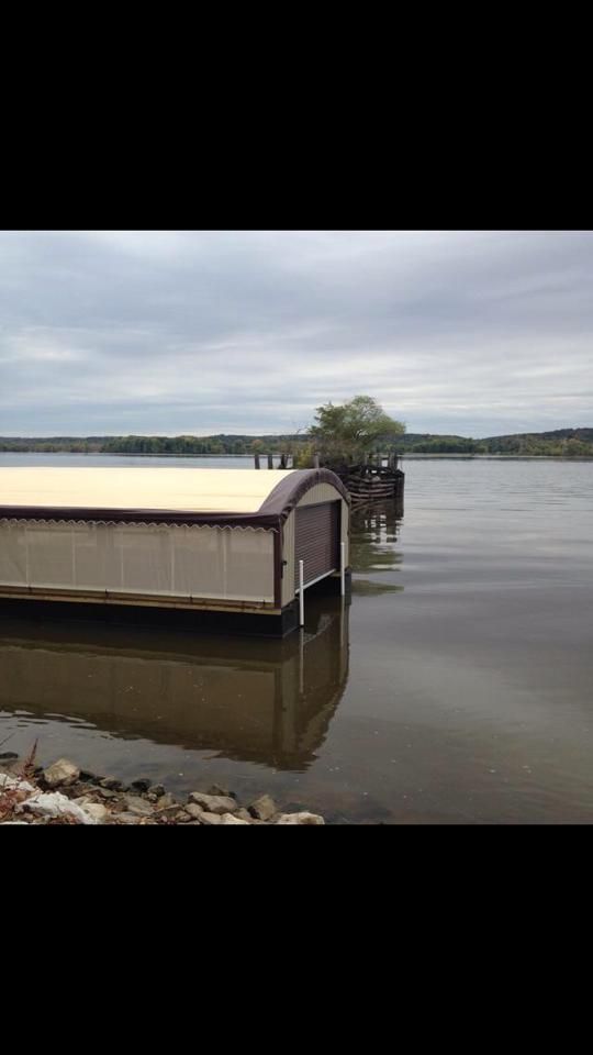 Boat dock on calm water under an overcast sky.