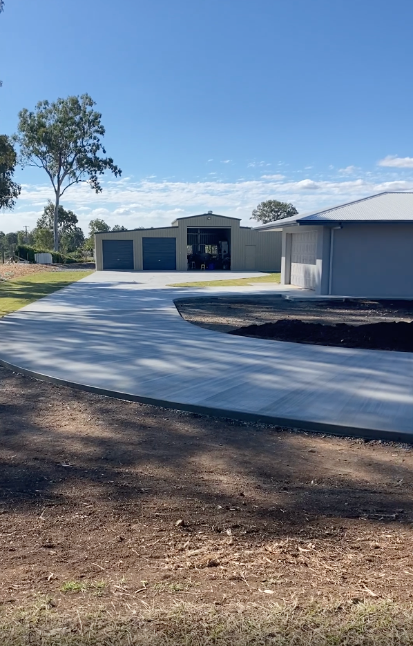 A Concrete Path With Dirt Either Side Of It Leading Up To A House — Peter Bishop Concreting In Gympie, QLD