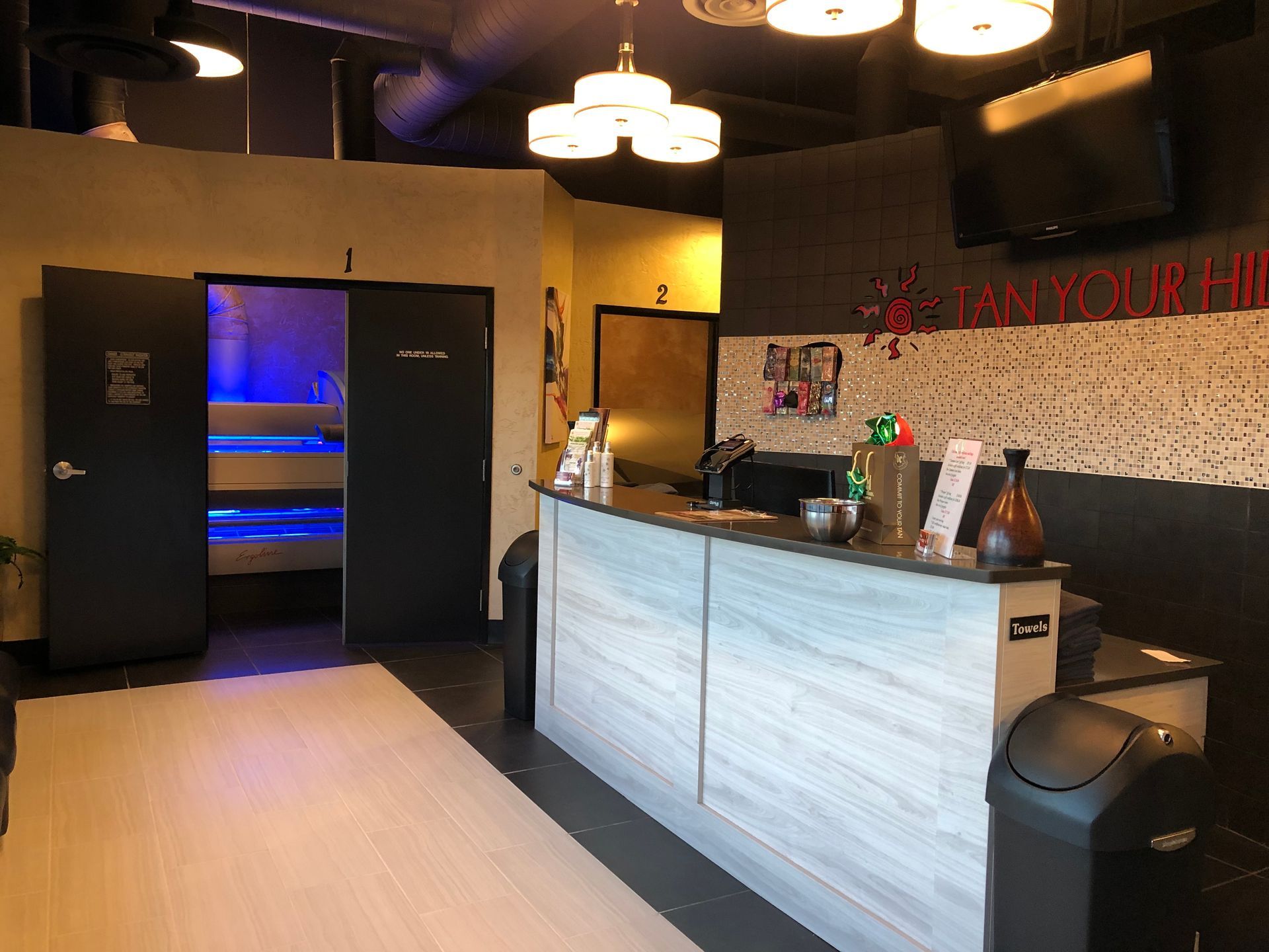 A room with a counter and a trash can in it