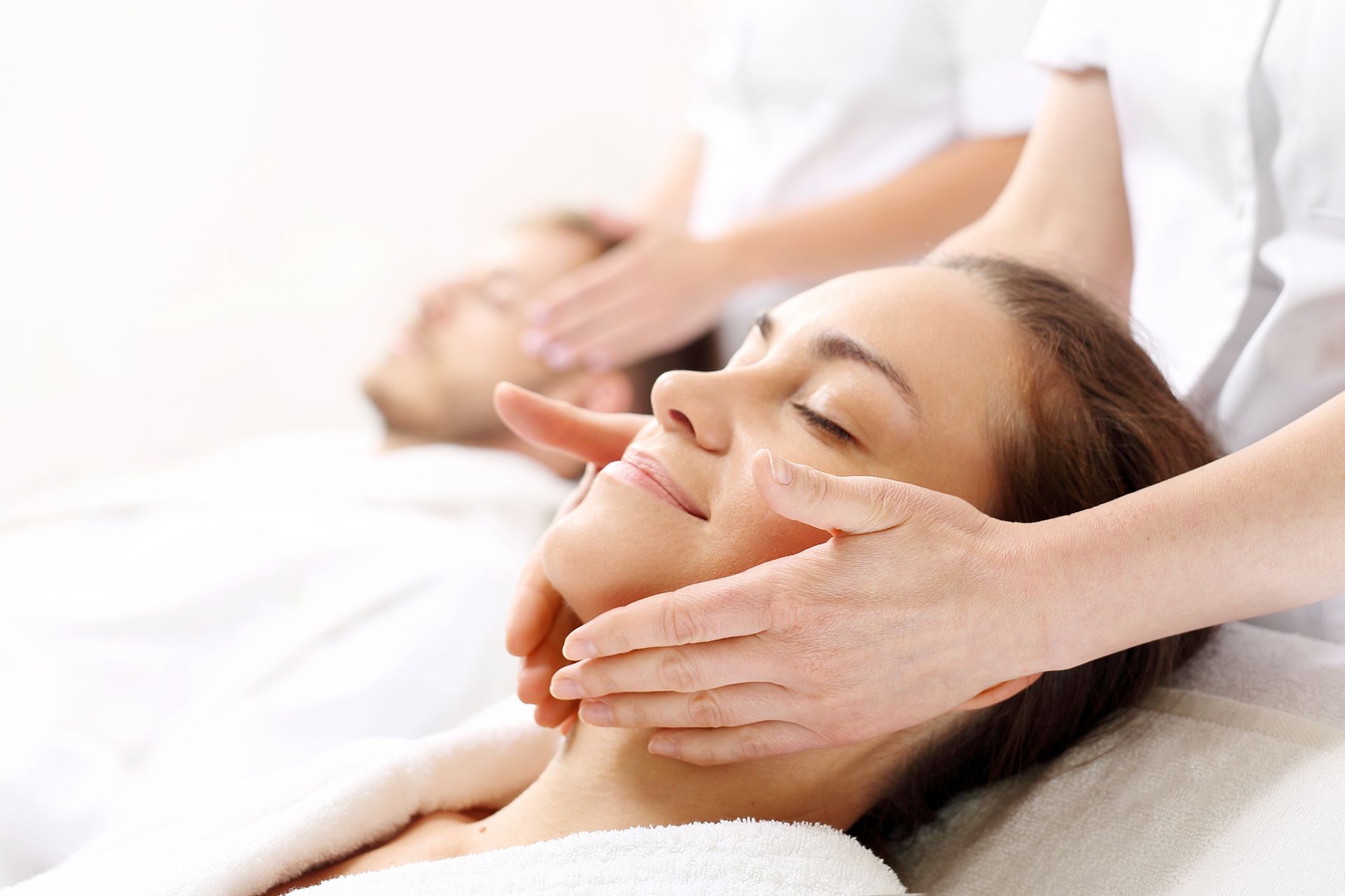 Woman receiving facial massage highlighting spa services, showcasing wellness and skin hydration.