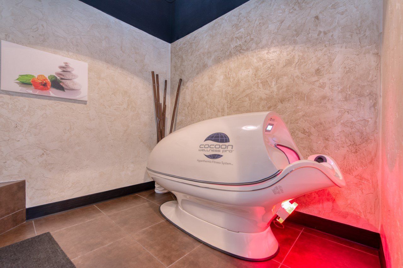 A white capsule is sitting in a room with red lights.