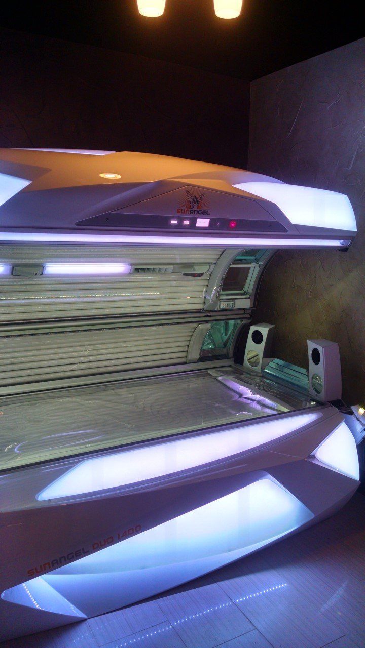 A tanning bed is sitting in a dark room.