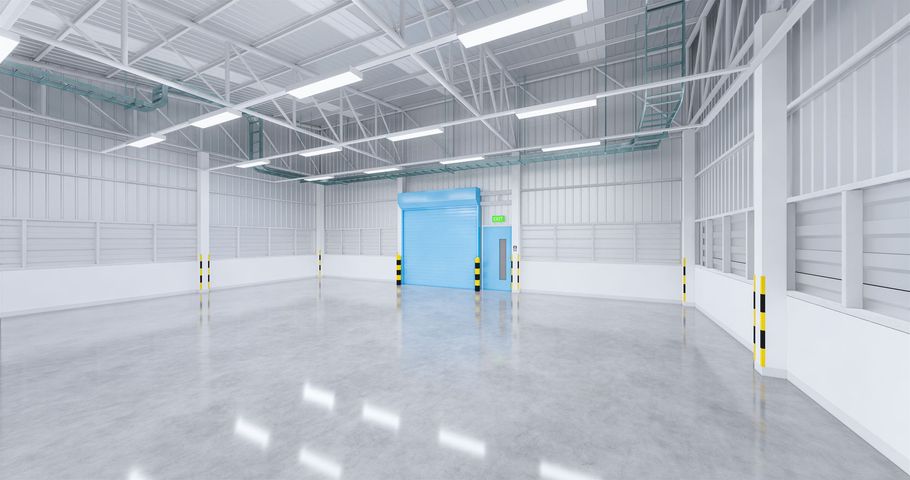 Empty white warehouse interior with polished concrete floor and a blue industrial door.