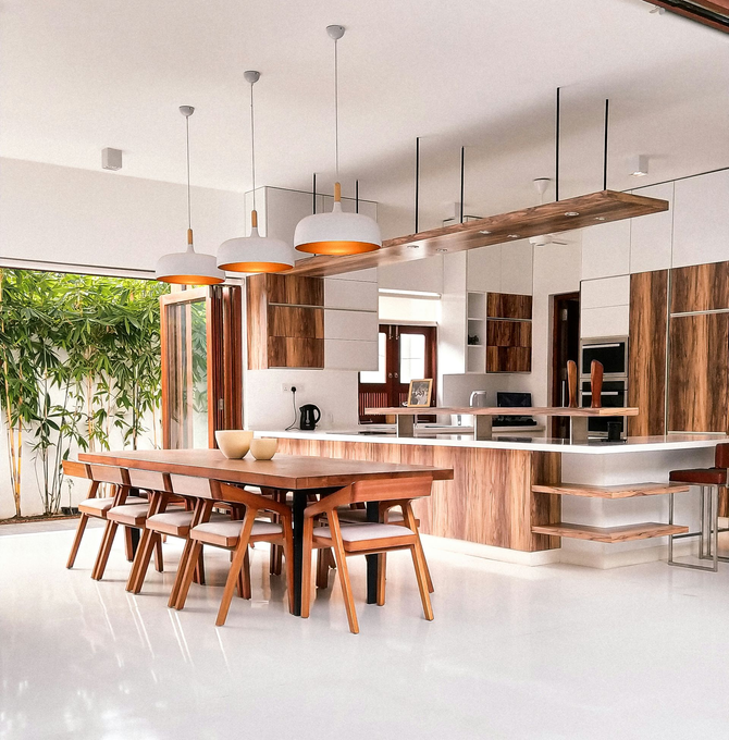 Modern open kitchen and dining room with wooden table, pendant lights, white floor, and large windows