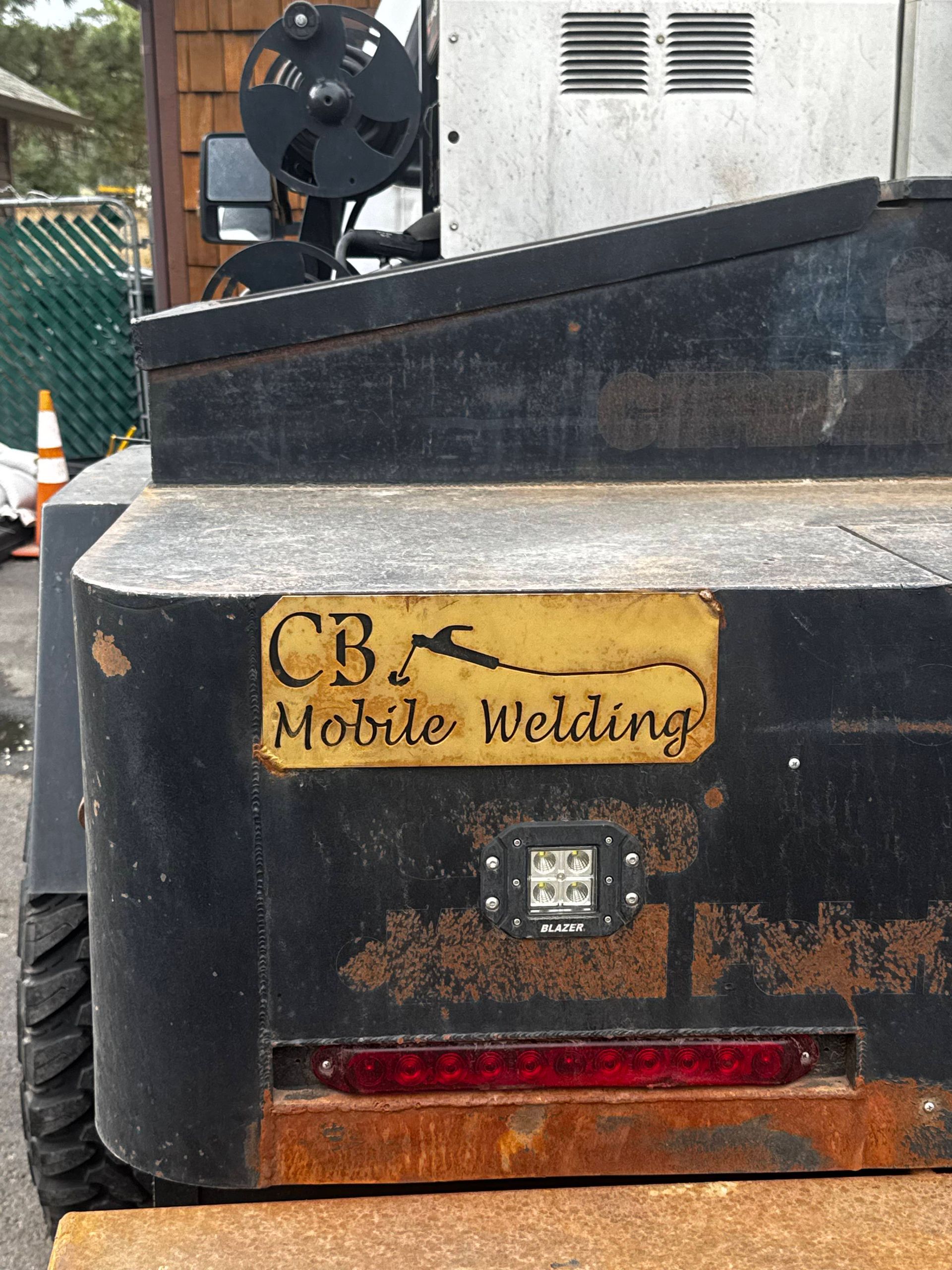 A white truck is parked in a grassy field.