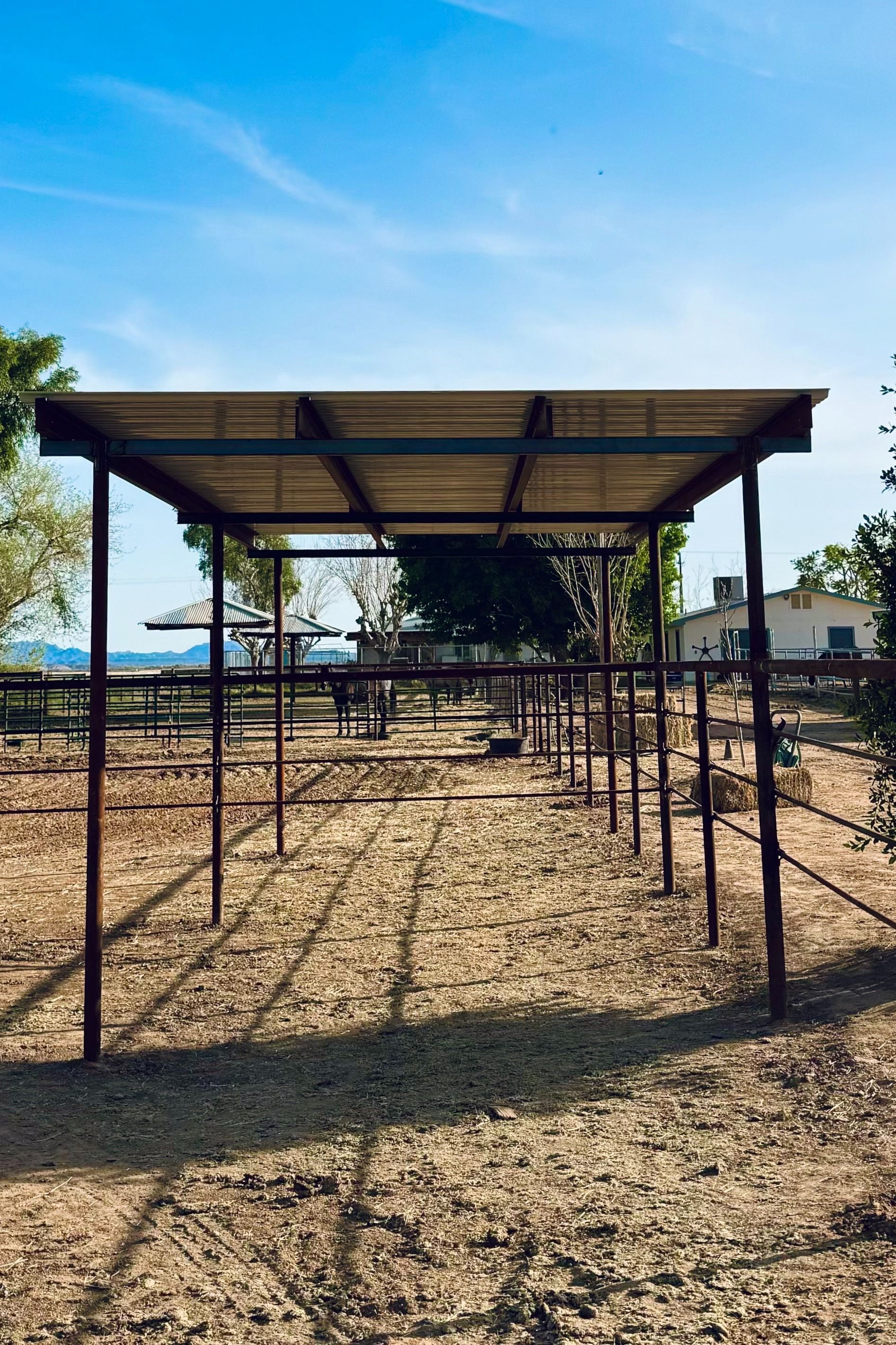 A fenced in area with a covered area in the middle of it.