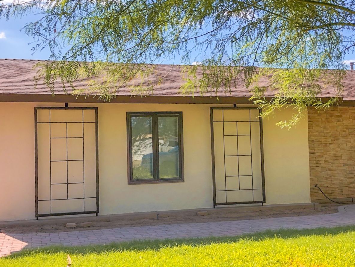 A house with a lot of windows and a tree in front of it.
