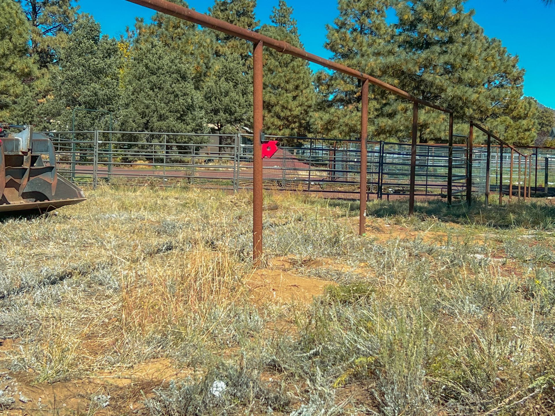 A fenced in area with a swing set in the middle of it.