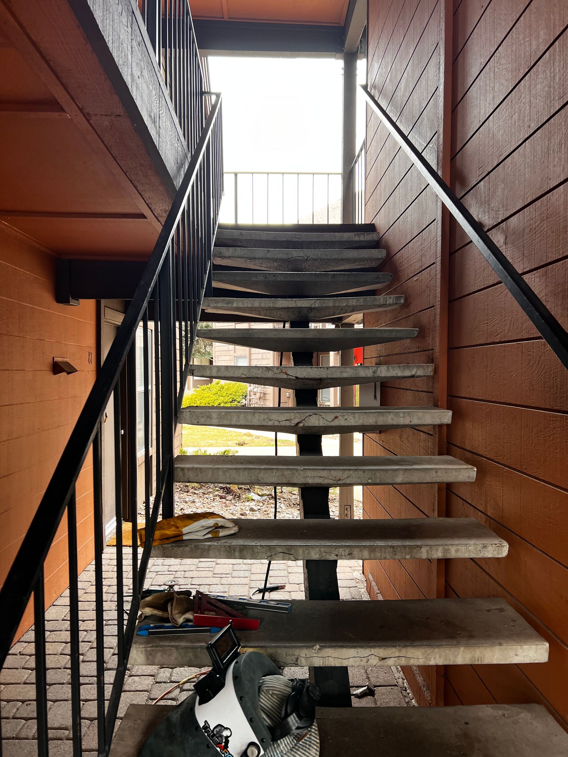 A large pile of rocks is behind a metal fence