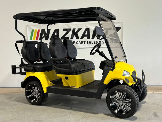 Yellow golf cart with black roof, seats, and wheels, parked indoors.