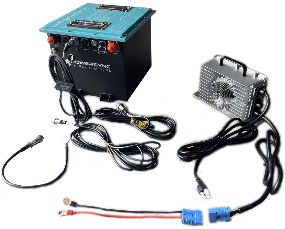 A black and teal power source with connected cables and a separate charger unit.