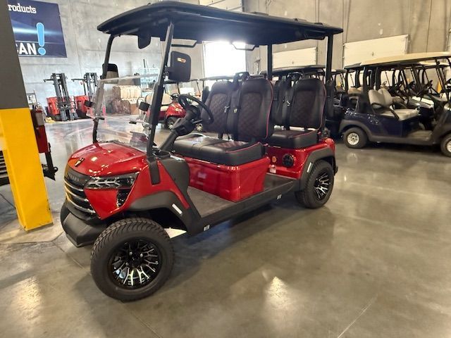 Yellow golf cart with black roof, seats, and wheels, parked indoors.