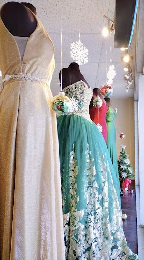 A row of dresses are on display in a store.