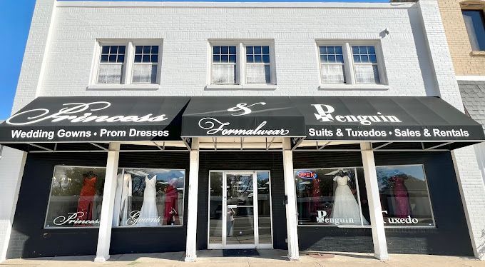 A white building with a black awning that says ' penguin ' on it