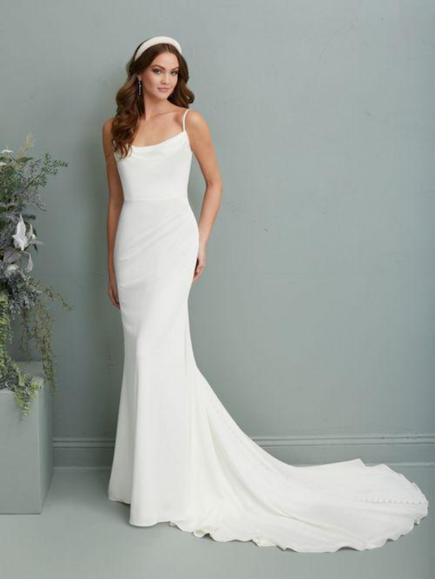 A woman is wearing a white wedding dress and a headband - Salina, KS - Princess & Penguin Formalwear