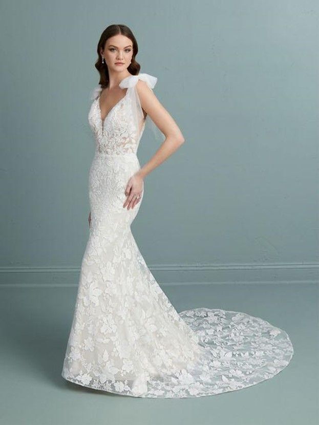 A woman is wearing a white lace wedding dress - Salina, KS - Princess & Penguin Formalwear