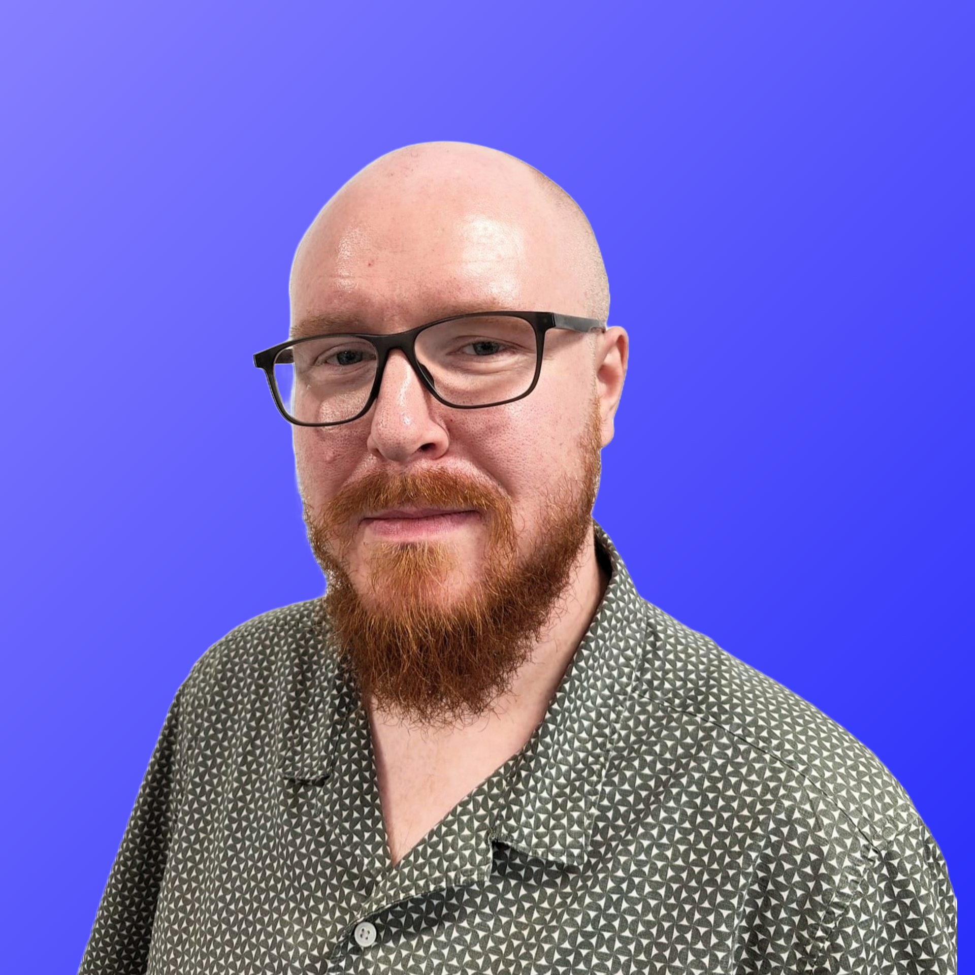 A man with a beard and a green shirt is standing in front of a blue background.