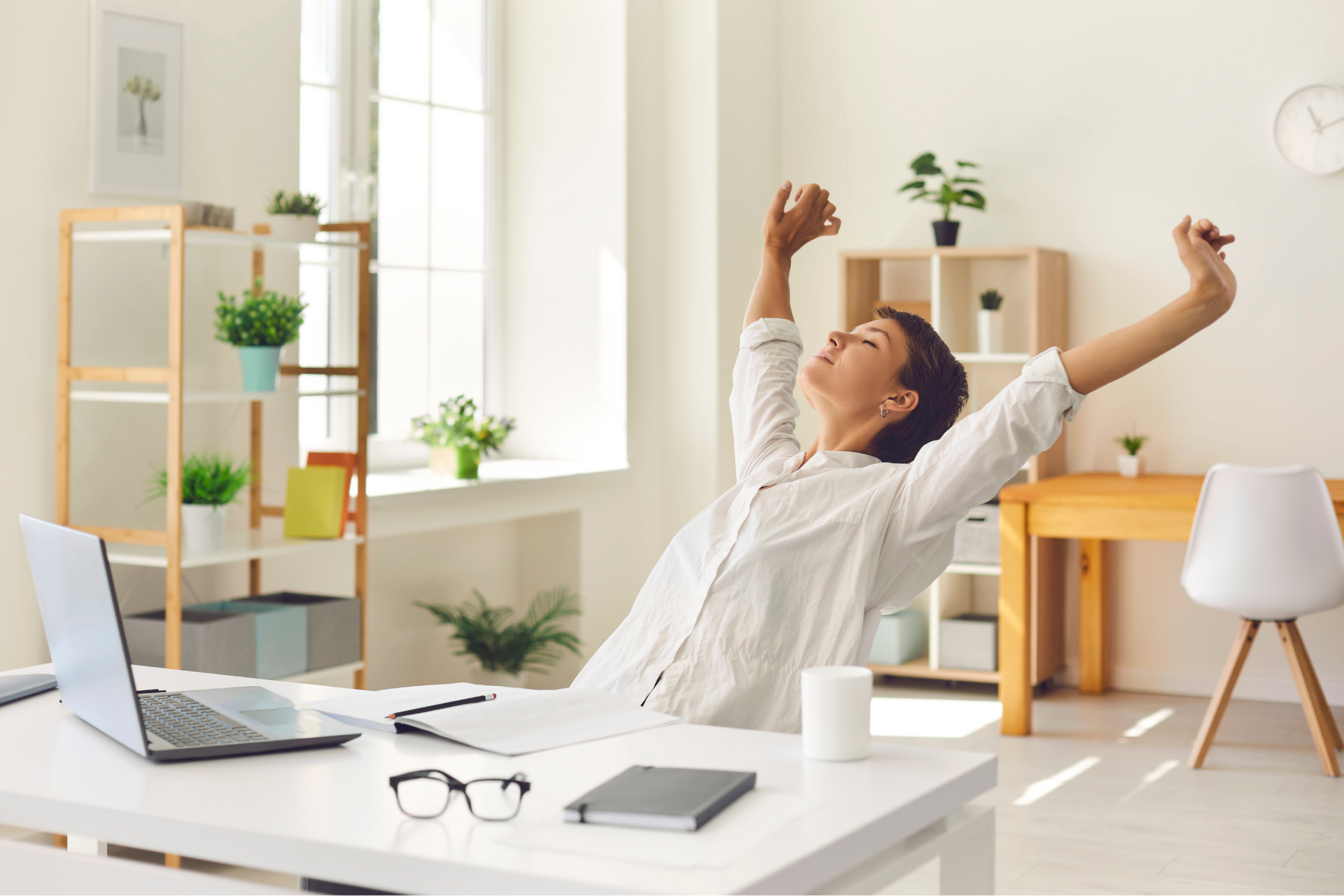 A woman stretches in her seat, living a life free from allergy flare-ups, thanks to Dupixent.