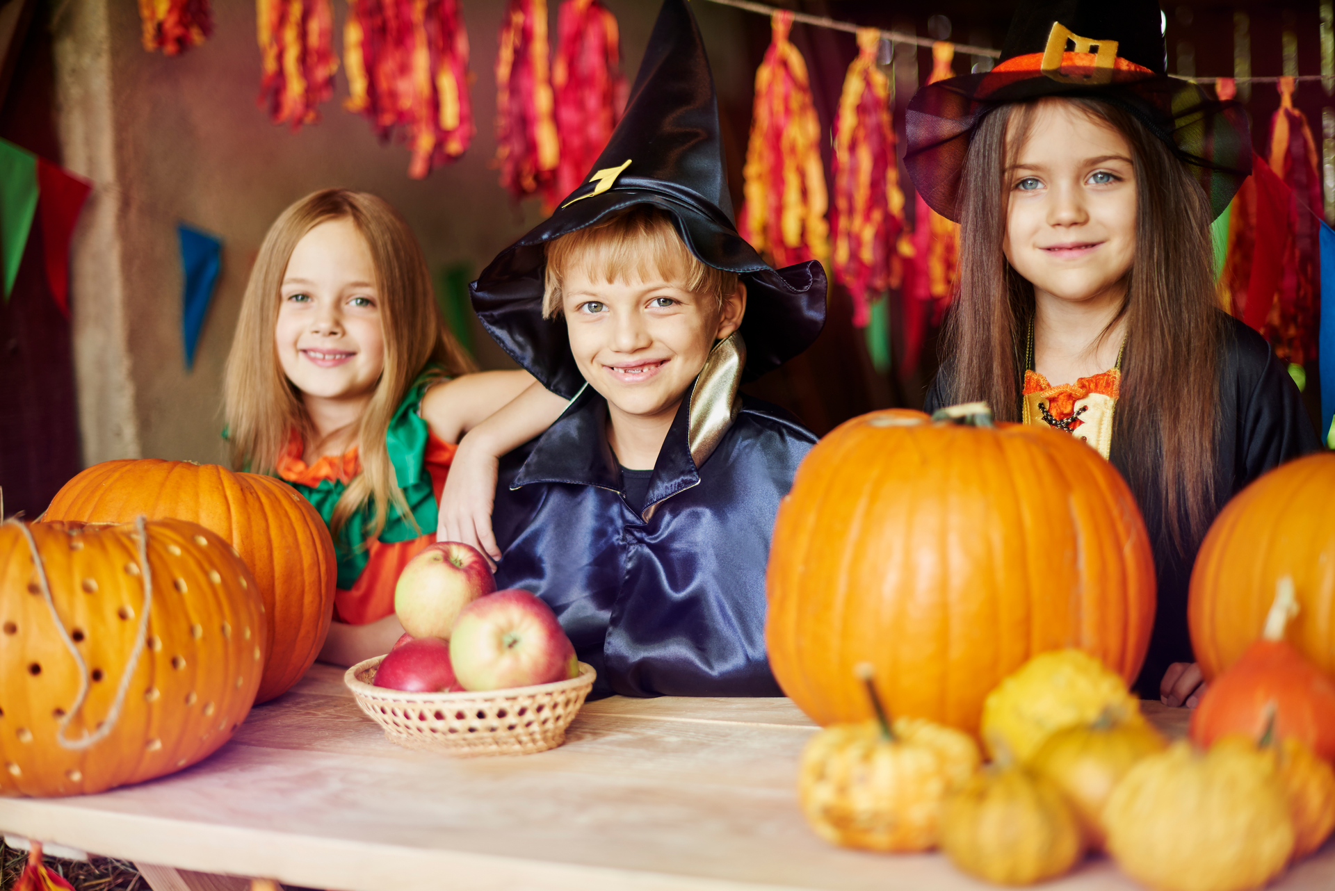 Three kids in their Halloween costumes getting ready to go trick-or-treating