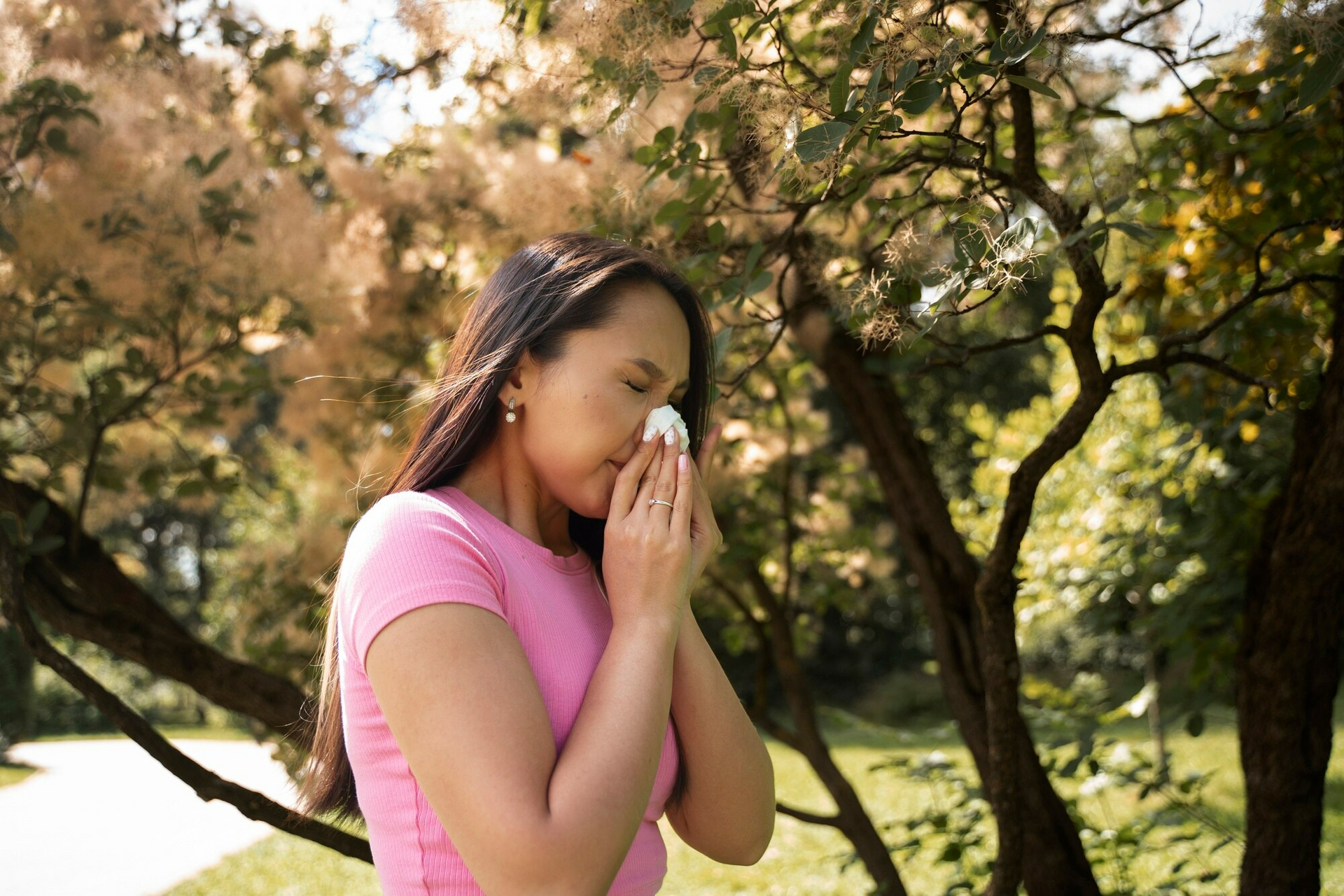 A woman suffering from pollen allergies in San Antonio during springtime