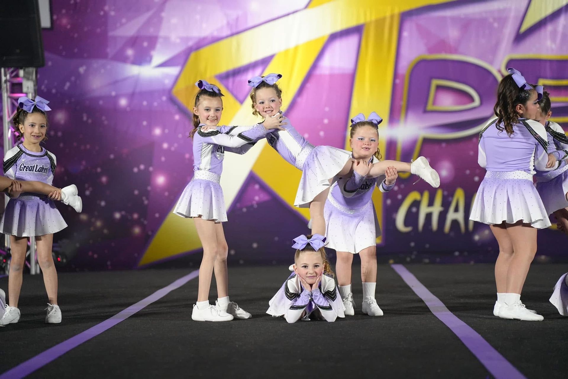 A group of cheerleaders are performing on a stage.