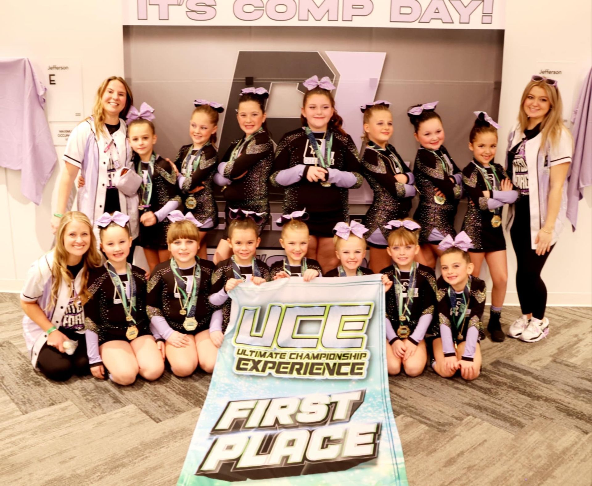 A group of cheerleaders holding a banner that says first place