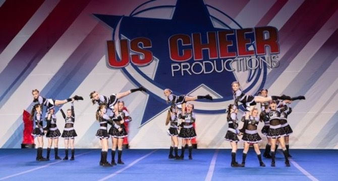 A group of cheerleaders are performing in front of us cheer productions
