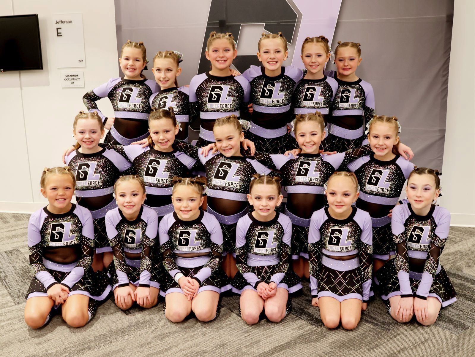 A group of cheerleaders are posing for a picture together.