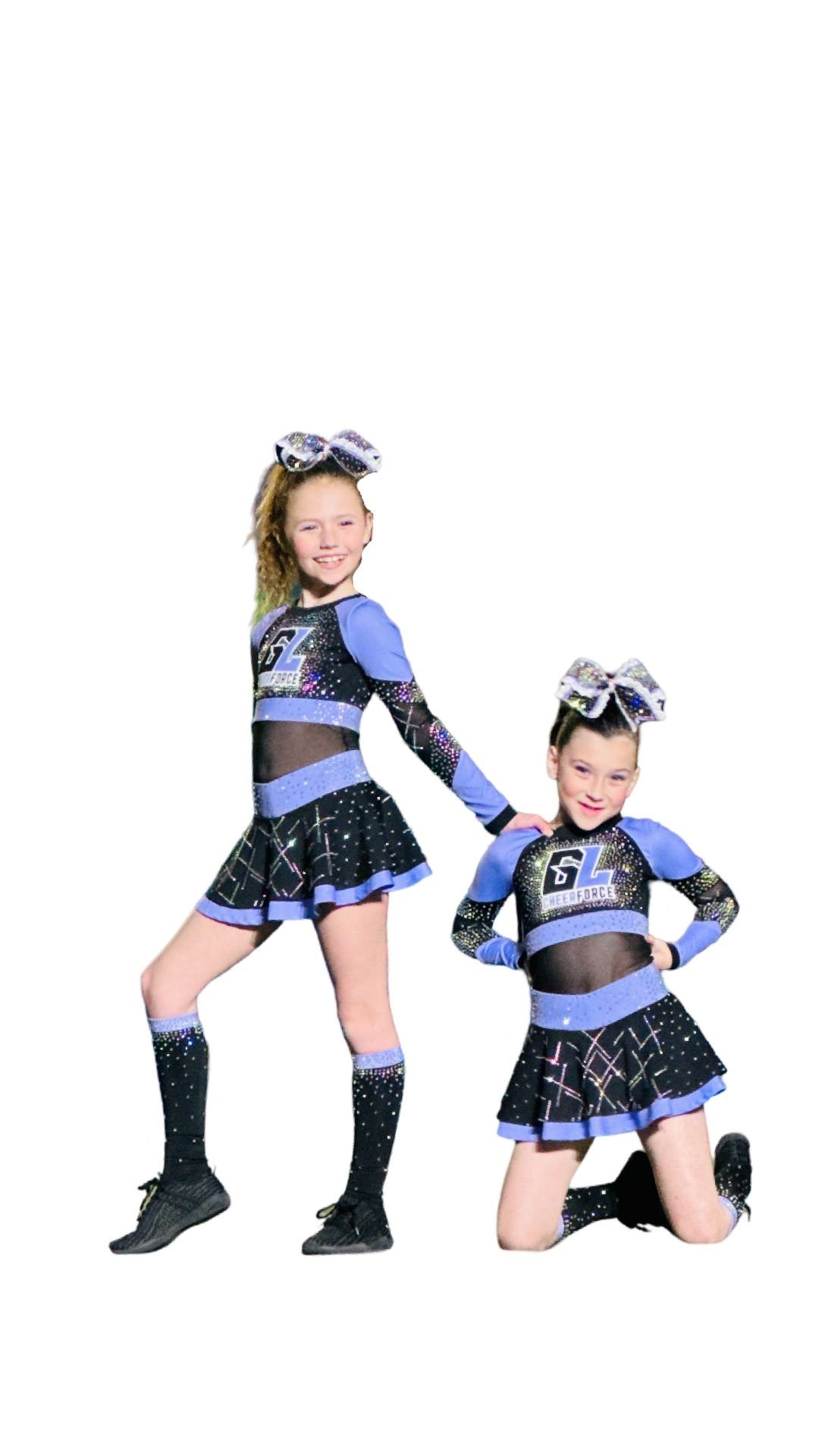 Two cheerleaders are standing next to each other on a white background.
