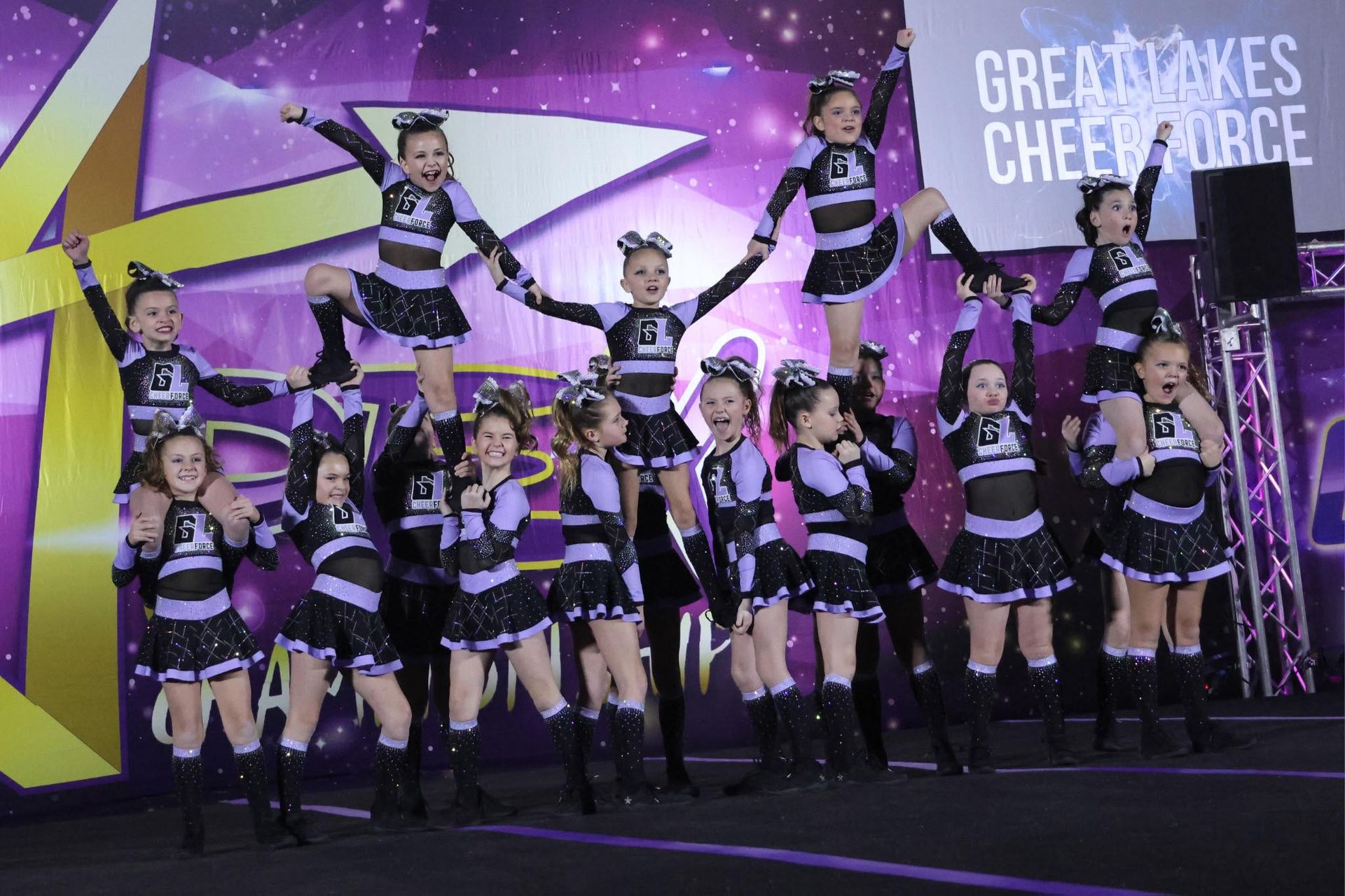 A group of cheerleaders are performing on a stage.