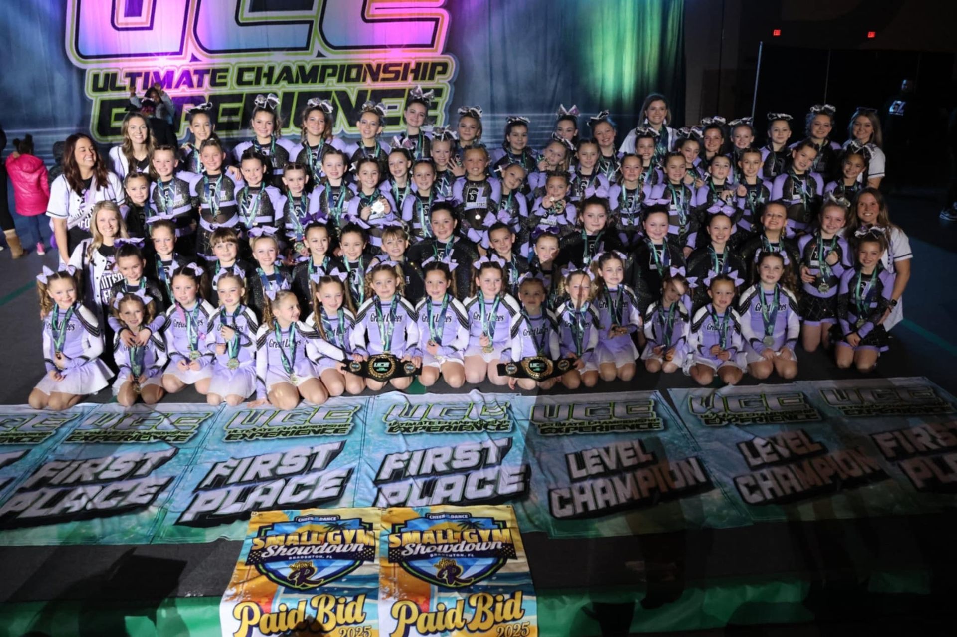 A group of cheerleaders are posing for a picture.