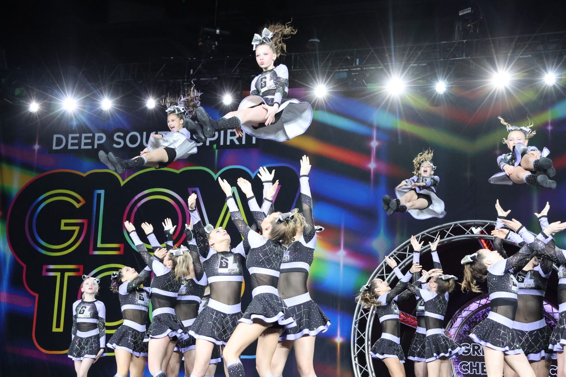 A group of cheerleaders are performing on a stage.