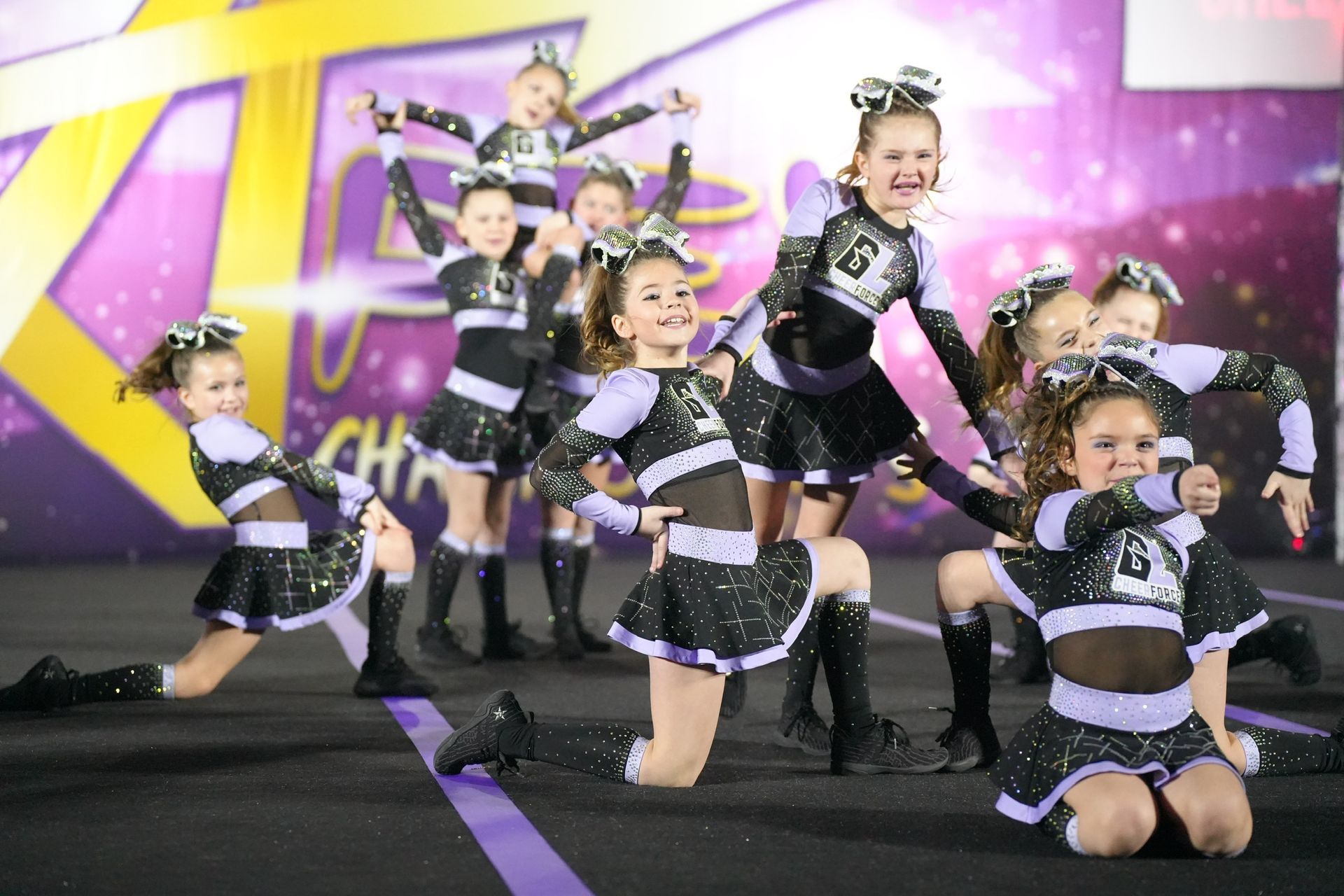 A group of cheerleaders are performing on a stage.