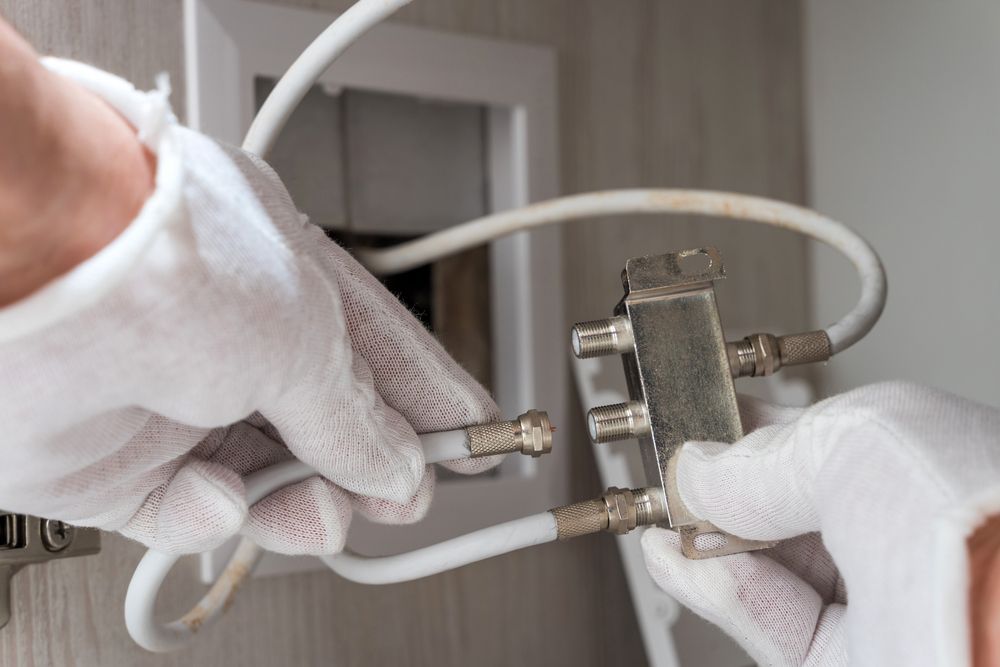 Person With White Gloves Connecting Coaxial Cables — Shane Kelly Communications in Lennox Head, NSW