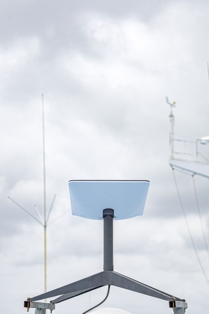 Blue Satellite Dish On Tripod Against A Cloudy Sky, Rooftop Setting — Shane Kelly Communications in Northern Rivers, NSW