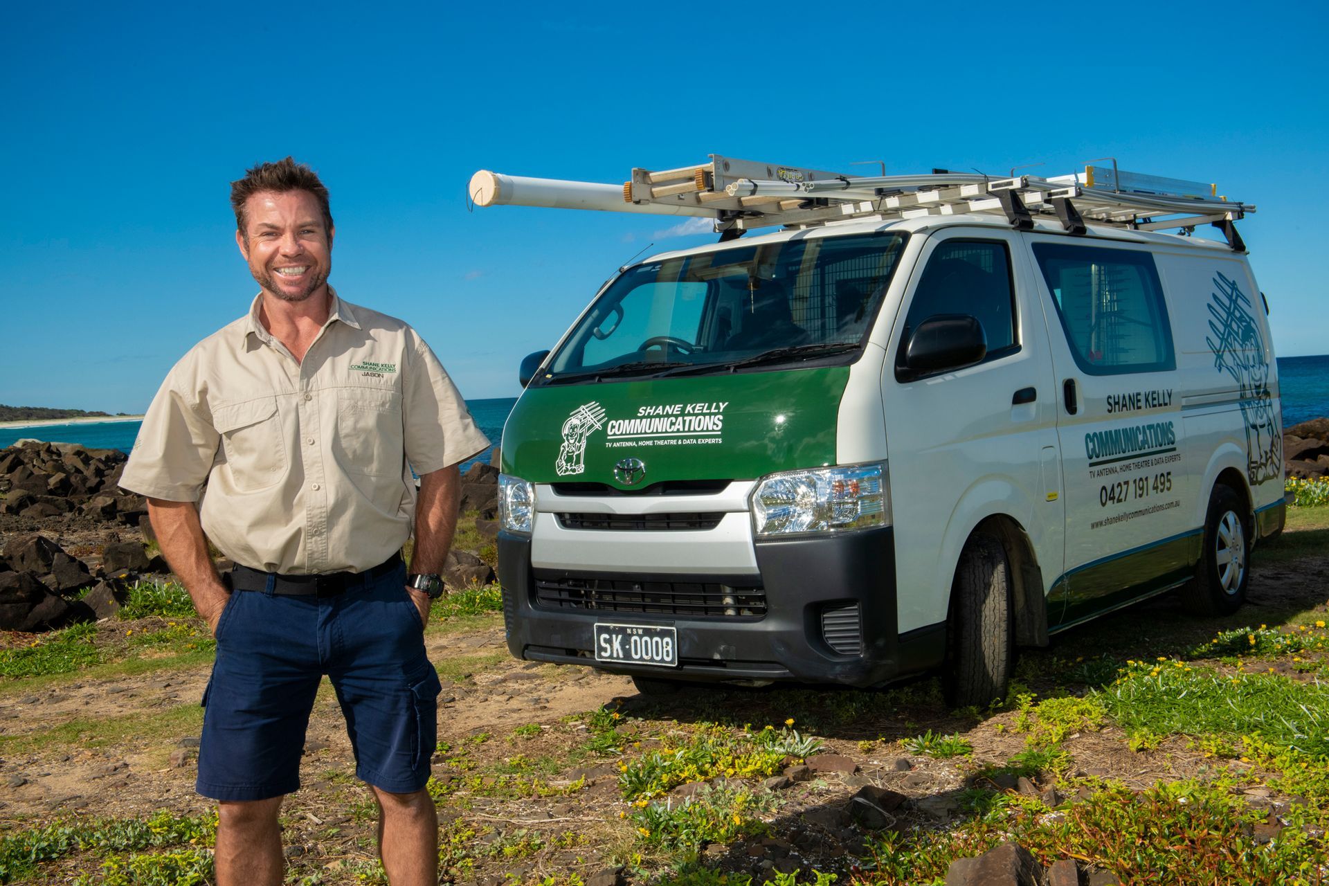 Man In Work Clothes Stands Beside A White Van, On A Coastal Landscape — Shane Kelly Communications in Northern Rivers, NSW
