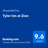 A blue sign that says ' awarded to tyler inn at zion ' on it